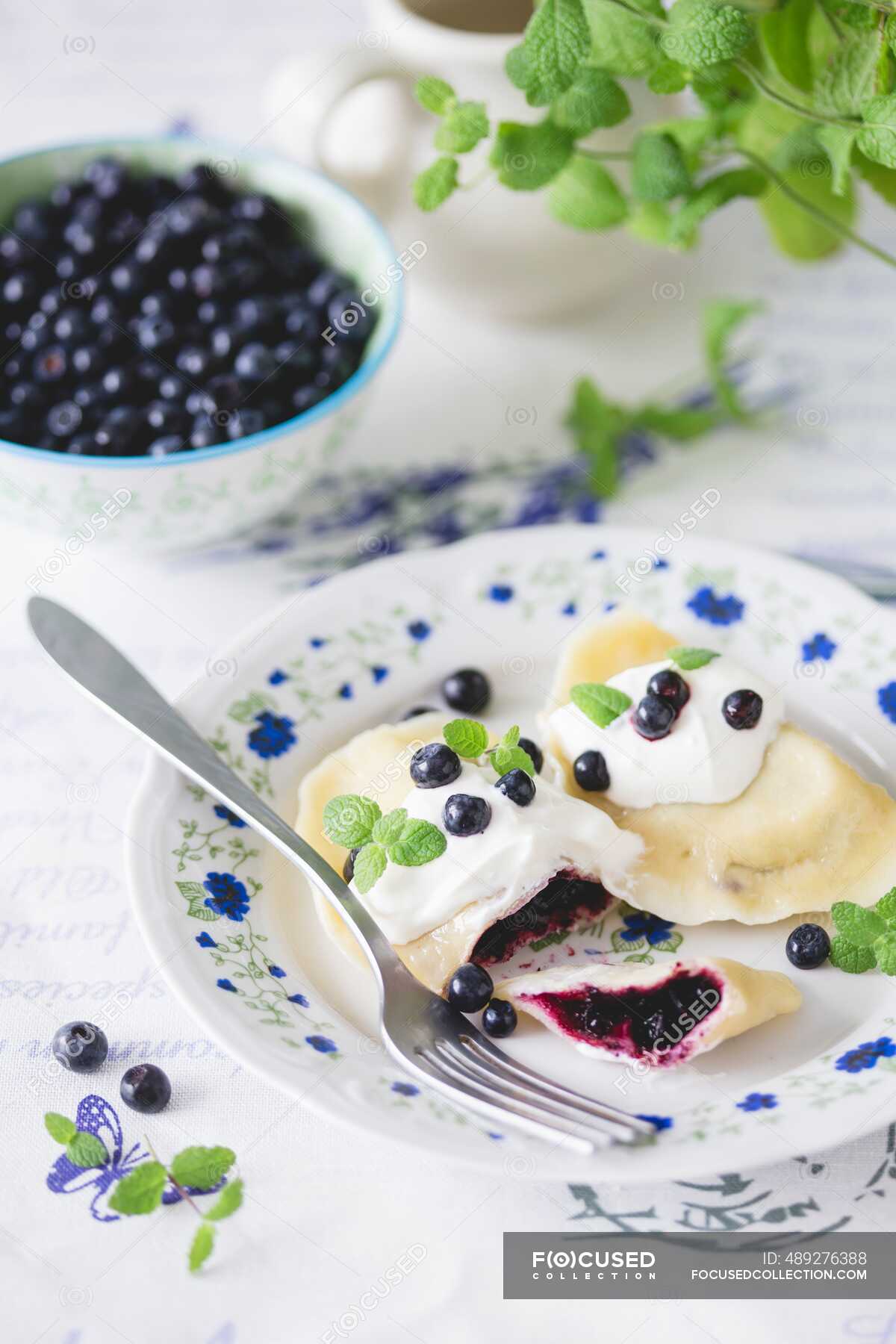 Traditional Polish Dumplings Pierogi With Blueberries And Sour Cream