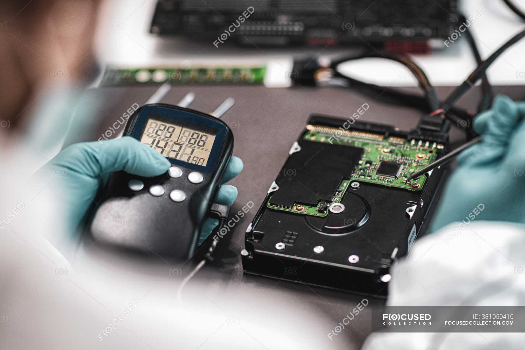 Female Digital Forensic Expert Examining Computer Hard Drive With