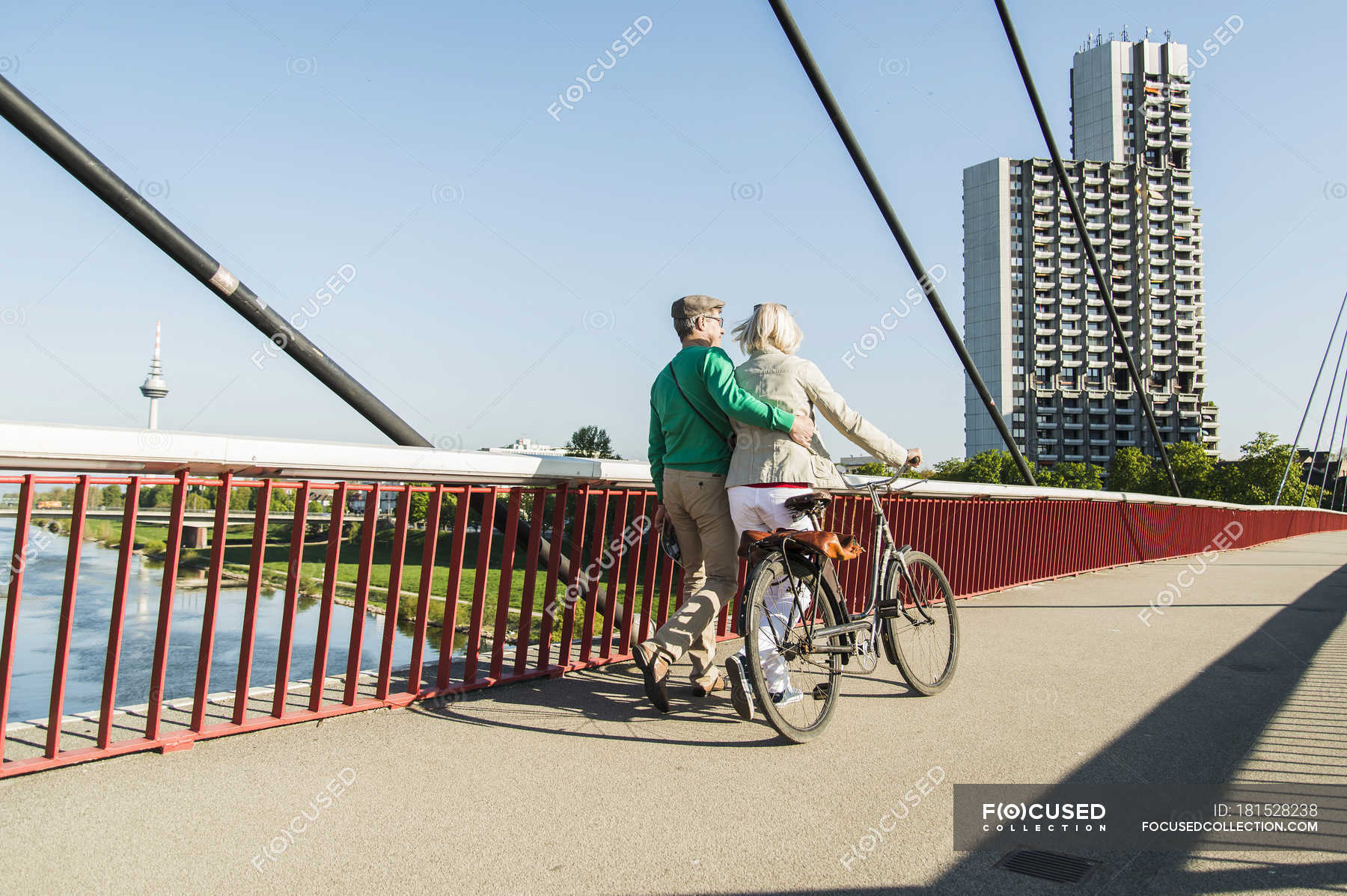 Germany Mannheim Mature Couple Crossing Bridge Pushing Bicycle