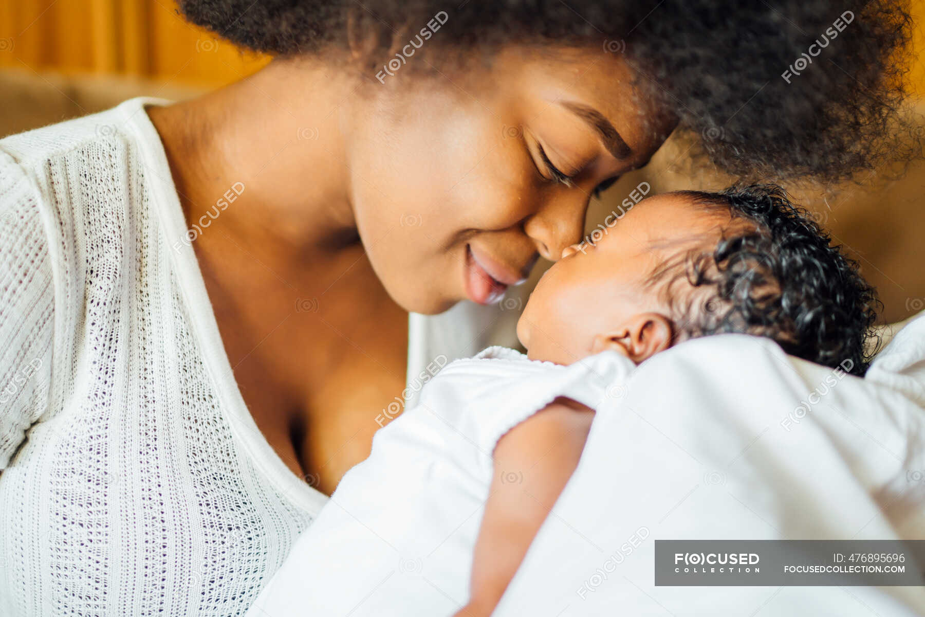 Close Up Of Mother Rubbing Noses With Newborn Daughter At Home S
