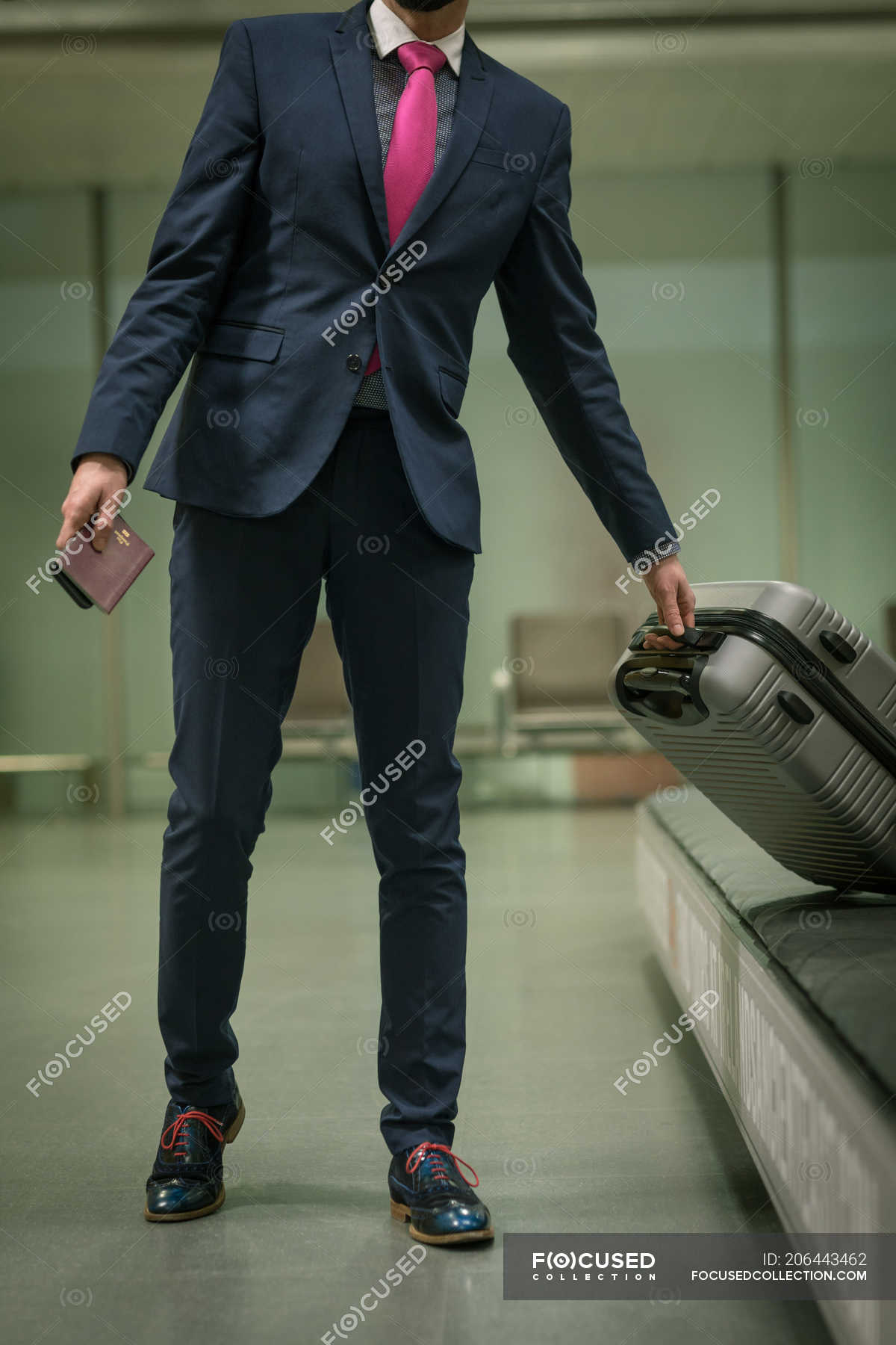 Businessman Taking Their Baggage From Baggage Carousel At Airport 40s