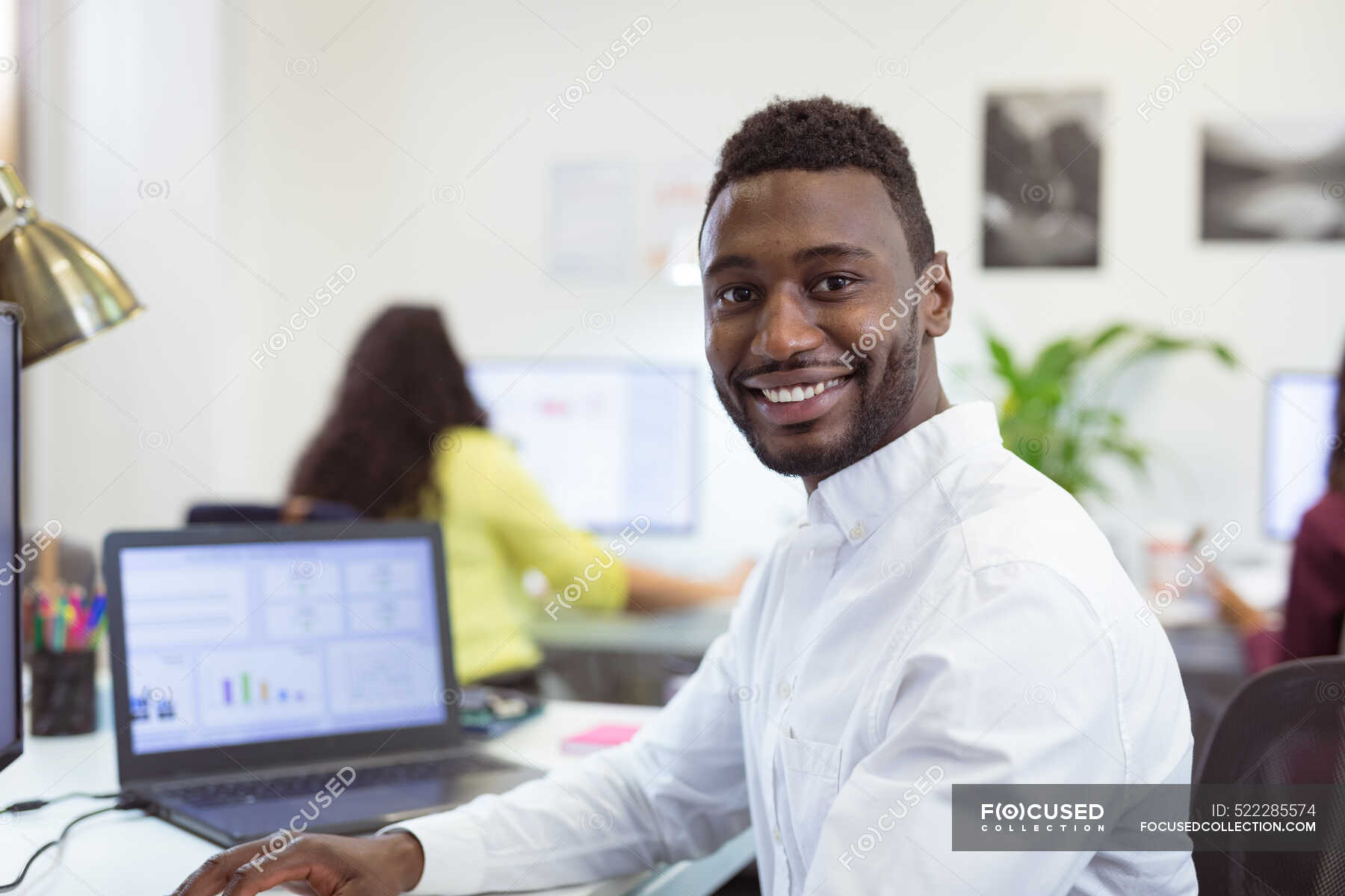 Portrait Of Smiling African American Businessman Looking At Camera In