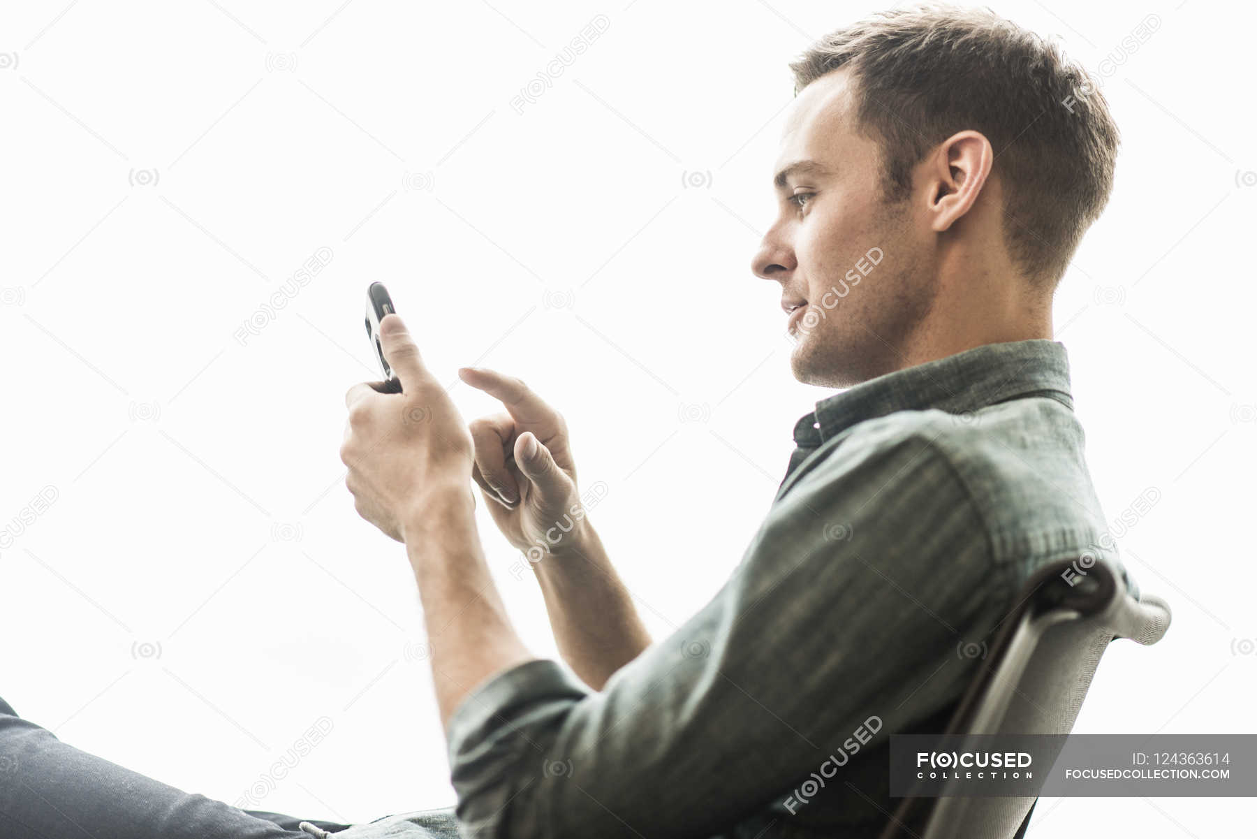 Man Sitting Checking His Phone Excitement Lifestyles Stock Photo