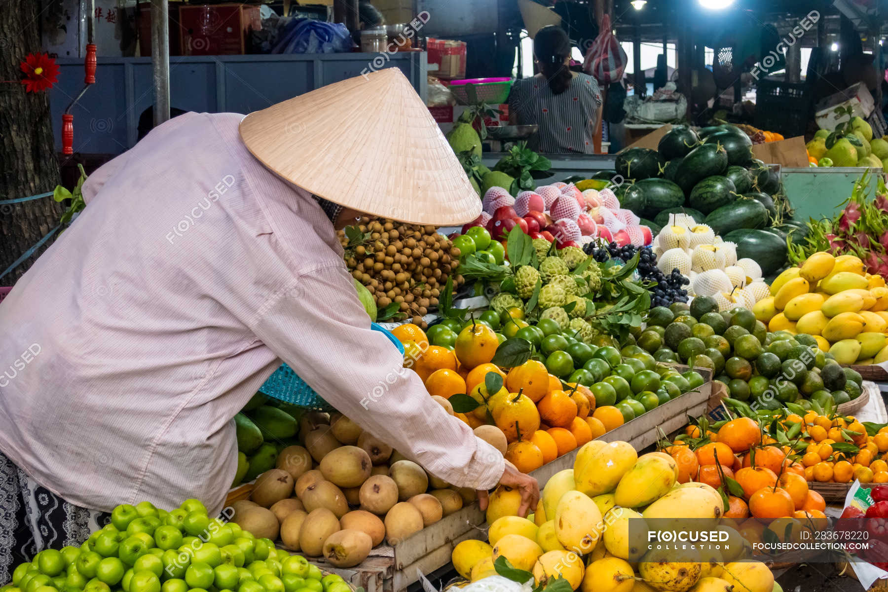 Vendors At Fruits And Vegetables Stalls At Local Market In Hoi An