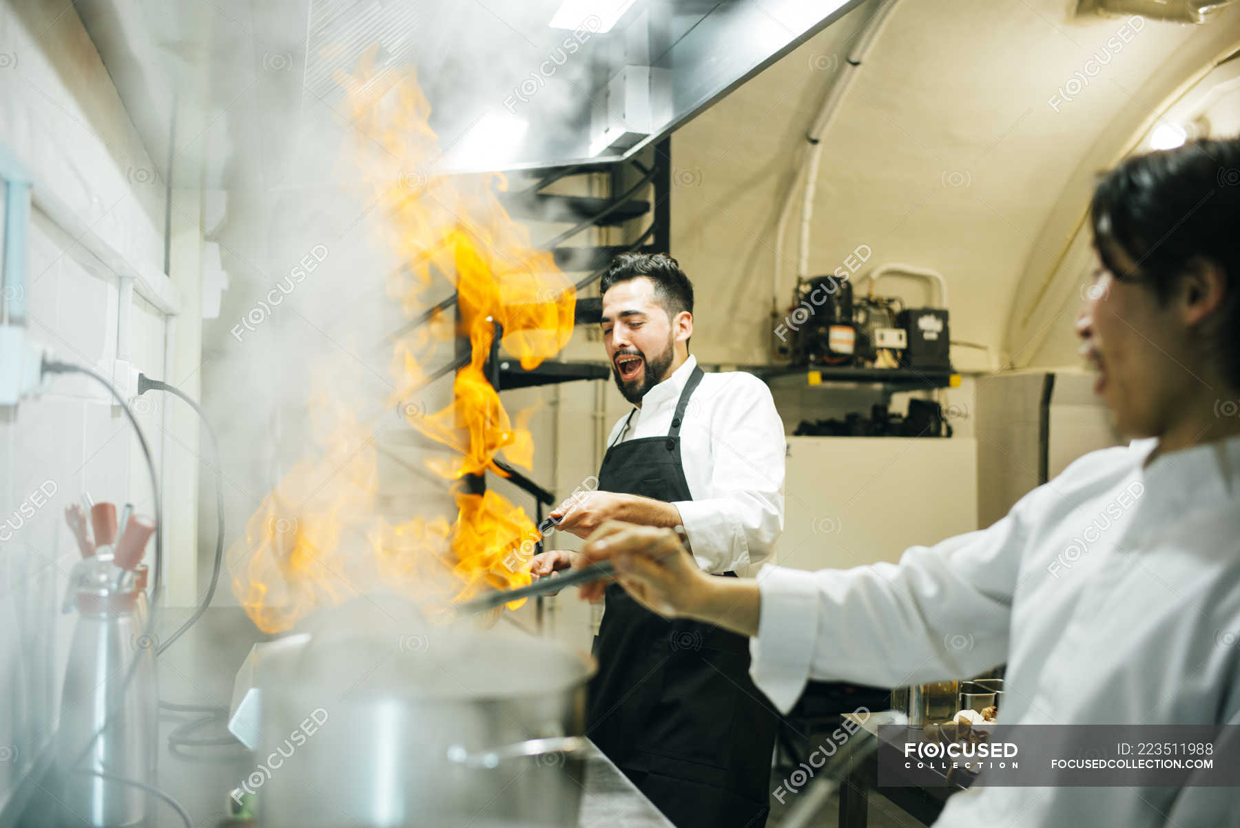 Cook Making Flambe In Restaurant Kitchen Fun Adults Stock Photo