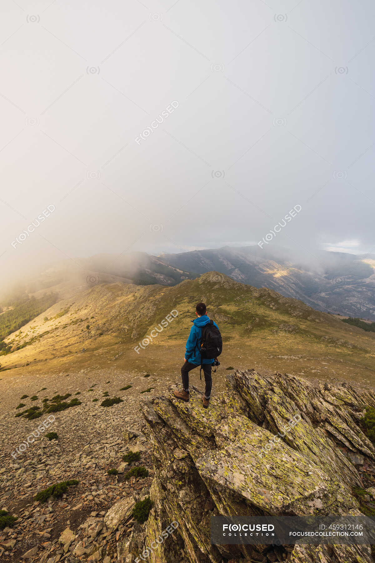 From Above Back View Of Anonymous Male Trekker With Rucksack Standing