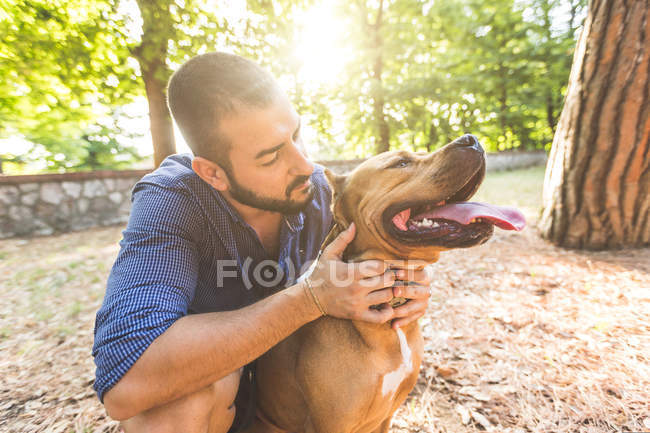 Portrait of a man with dog at park — Stock Photo