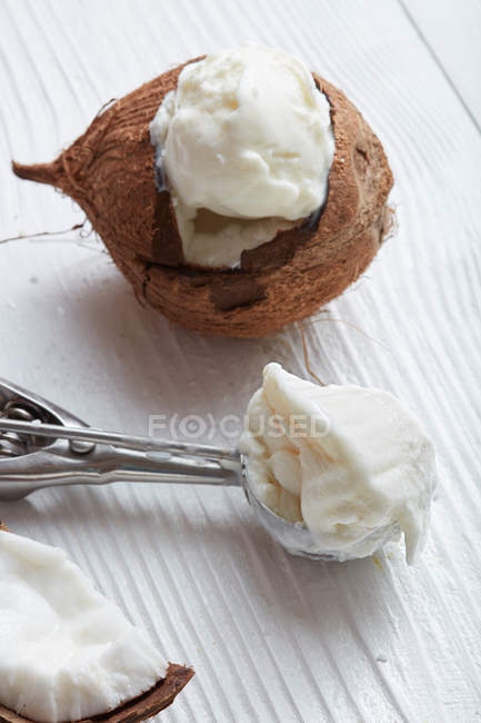 Ice cream in coconut and spoon — Stock Photo