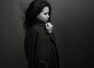 Girl in oversize coat looking away — Stock Photo