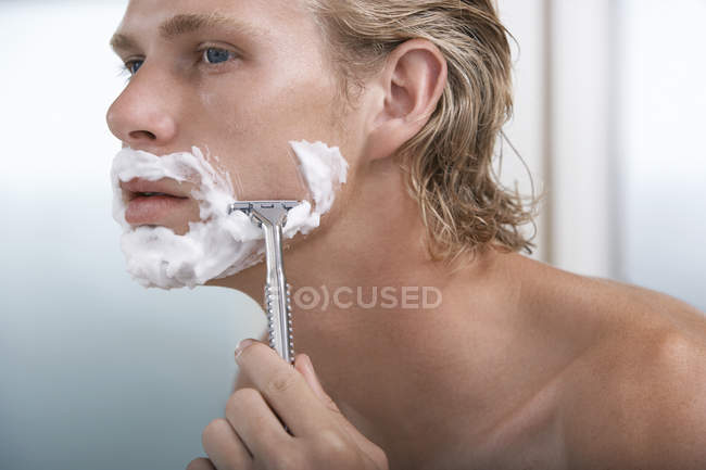 Young Man shaving — Stock Photo