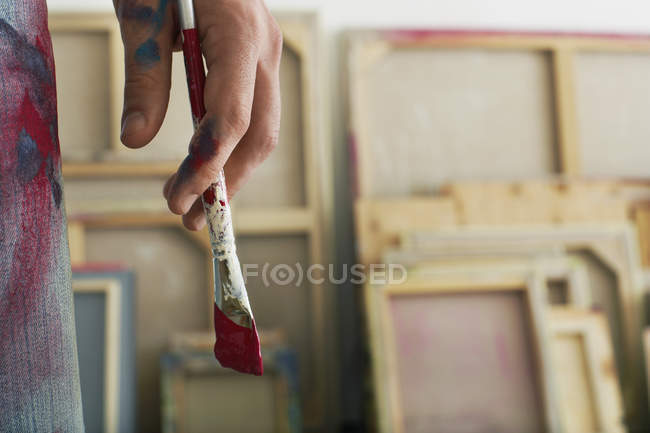 Artist holding paint brush — Stock Photo