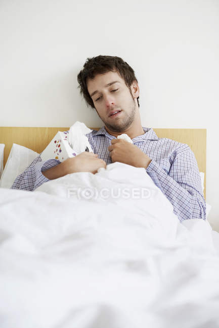 Ill Man with flue in bed — Stock Photo