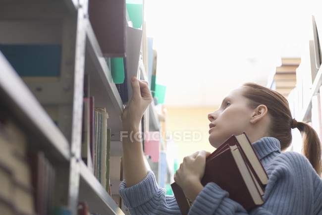 Young woman with library books — Stock Photo