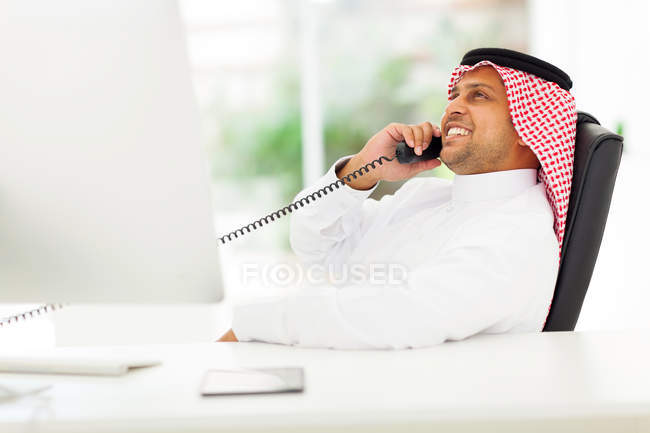 Arabian corporate worker talking on the phone — Stock Photo