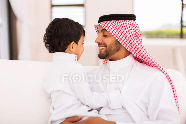 Father and son sitting at home — Stock Photo