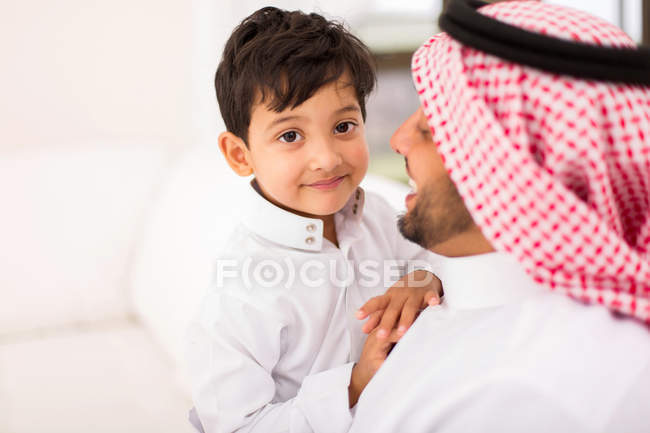 Father and son sitting at home — Stock Photo