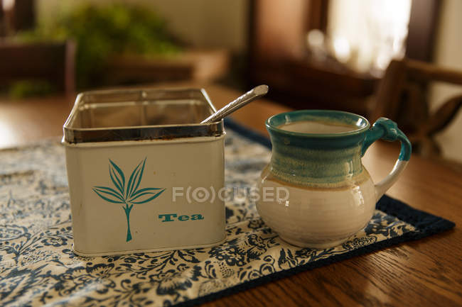 Cup and tea box — Stock Photo