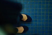 Woman standing on the tile — Stock Photo