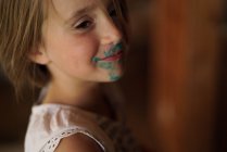 Girl with green paint on the face — Stock Photo