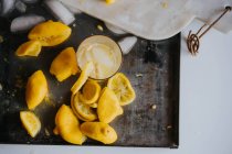 Прямо над видом на стакан лимонада на подносе с ингредиентами — стоковое фото