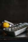 Still life of ice tray with lemon and grater — Stock Photo