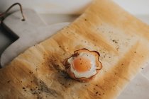 Delicious baked egg basket on baking paper over marble cutting boards — Stock Photo