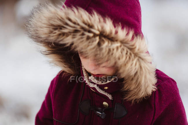 Little girl in red hood hiding face — Stock Photo