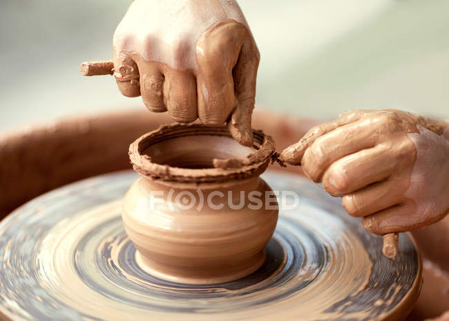 Hands working on pottery wheel — Stock Photo