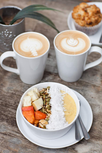 Deux tasses de café chaud Latte Art avec muffin et muesl cru de fruits — Photo de stock