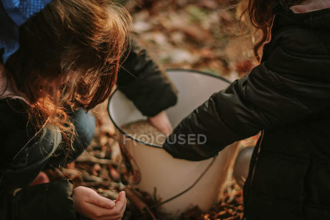 Girls taking food for chickens — Stock Photo