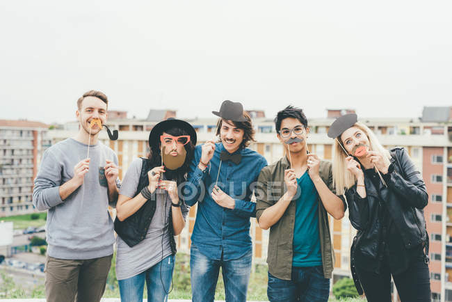 Multiethnische Freunde posieren mit Masken — Stockfoto