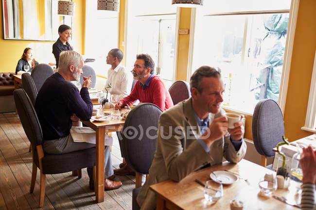 Customers and a waitress in restaurant interior — Stock Photo