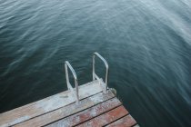 Wooden jetty on water — Stock Photo