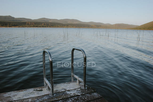 Wooden jetty on river — Stock Photo