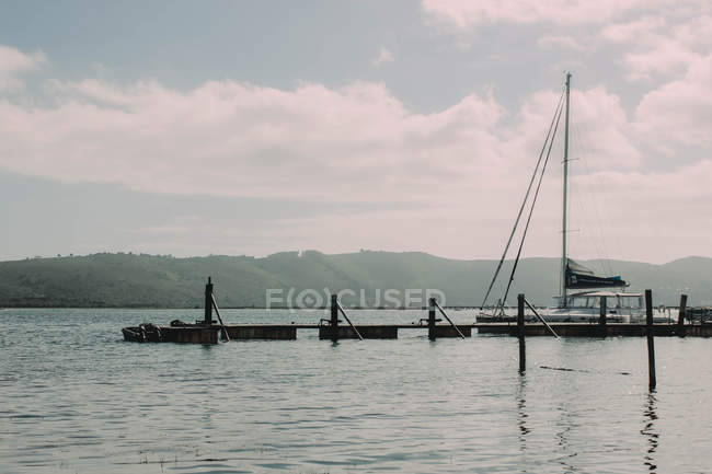 Yacht moored near pier — Stock Photo