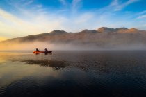 Canoe pass through fog — Stock Photo