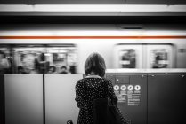 Mädchen steht vor fahrendem Zug — Stockfoto