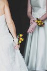 Couple with bouquets on hands — Stock Photo