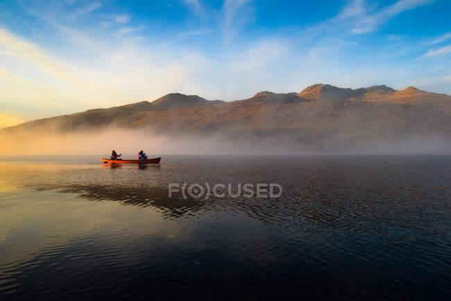 Canoe pass through fog — Stock Photo