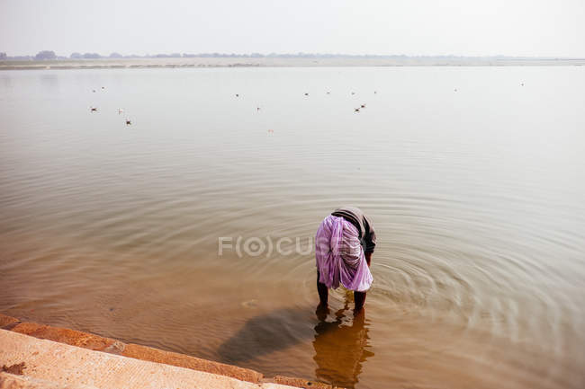 Indian man in water — Stock Photo