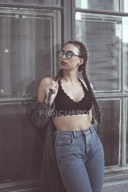 Woman in glasses leaning on window — Stock Photo