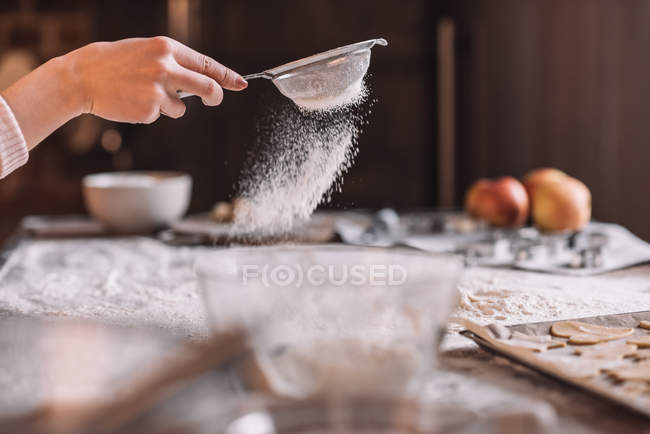 Hand sifting flour — Stock Photo