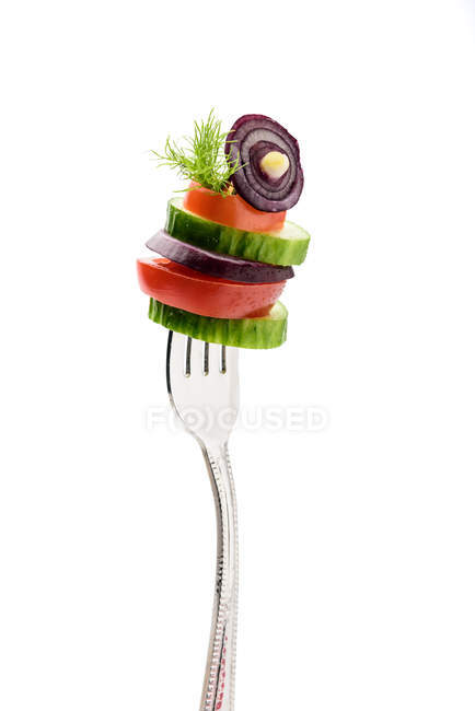 Sliced vegetables on fork — Stock Photo