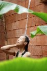 Woman taking outdoor shower — Stock Photo