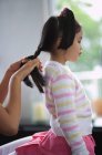 Girl braided by mother — Stock Photo