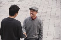 Grandfather and grandson shake hands — Stock Photo