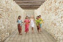 Happy Balinese girls running — Stock Photo