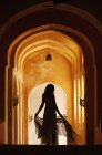 Woman in arched hallway — Stock Photo