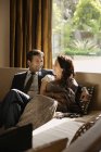 Couple sitting on couch — Stock Photo