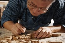 Craftsman carving wood — Stock Photo